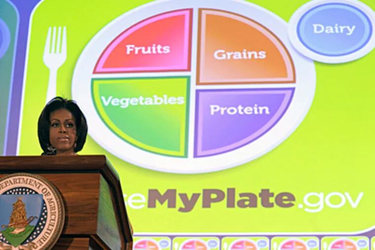 Michelle Obama helps introduce the new food guide. A goal, she said, is making the system simpler for parents. (Susan Walsh / Associated Press)