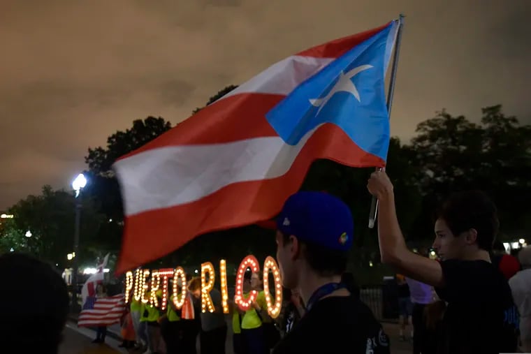 People gather outside the White House last September during a vigil commemorating the one-year anniversary of Hurricane Maria hitting Puerto Rico.