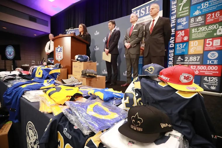 Fake merchandise displayed on a table as the National Football League and law enforcement agencies announced seizures of fake merchandise and tickets in January 2019, at a press conference in Atlanta. (Curtis Compton/Atlanta Journal-Constitution/TNS)