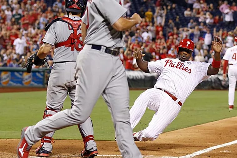 Ryan Howard slides into home plate. (Ron Cortes/Staff Photographer)