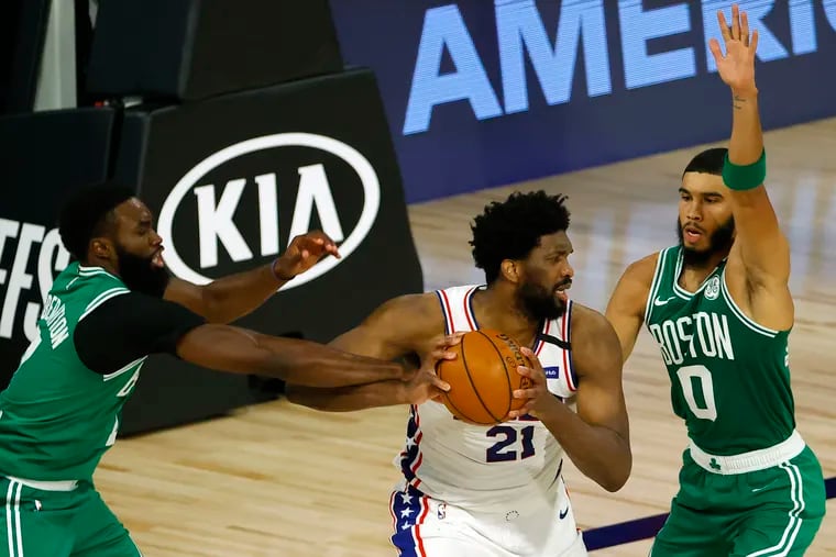 Joel Embiid (center) is pressured by Bosotn's Jaylen Brown (left) and Jayson Tatum in a playoff game in August. The three could meet against next month.