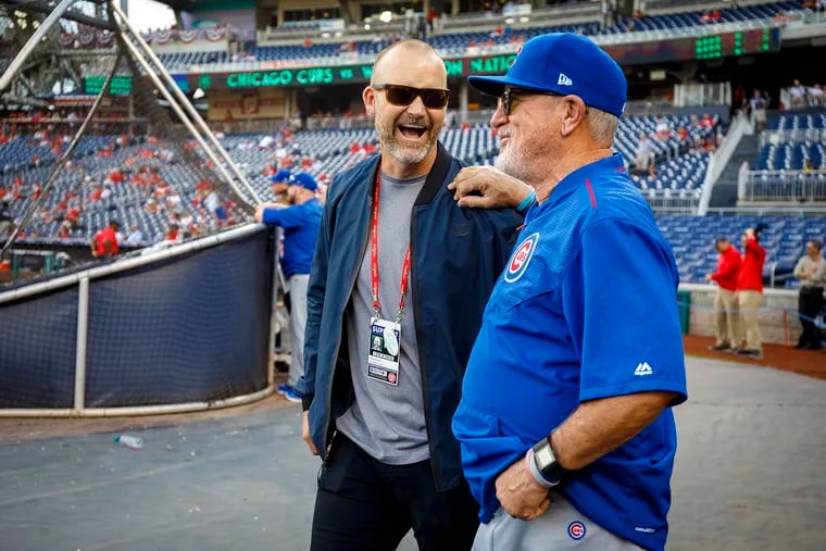 Former Chicago Cubs catcher David Ross (left) visits with manager Joe Maddon in 2017.
