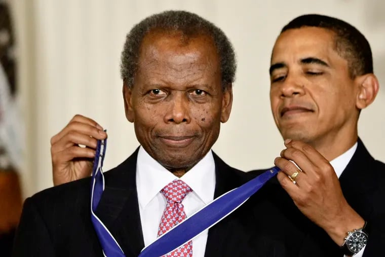 Then-President Barack Obama presents the Presidential Medal of Freedom to Sidney Poitier during ceremonies in the East Room at the White House in 2009.