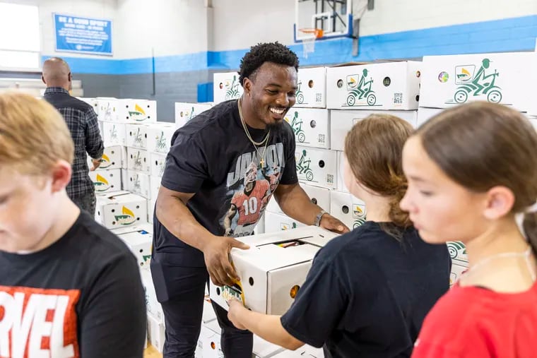 Nakobe Dean, (17) Eagles Line Backer, visits the Boys and Girls Club in Northeast Frankford, to say hello to the kids and donate Food for them and their families in Philadelphia, Pa., on Tuesday, May 16, 2023. Dean was a part of the Boys and Girls Club back in his hometown in Mississippi.