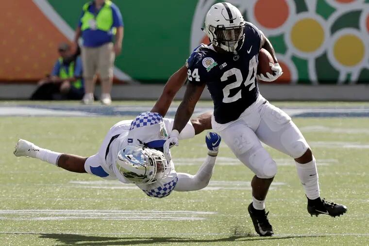 Miles Sanders rushes past Kentucky's Davonte Robinson during Penn State's Citrus Bowl loss on Tuesday.