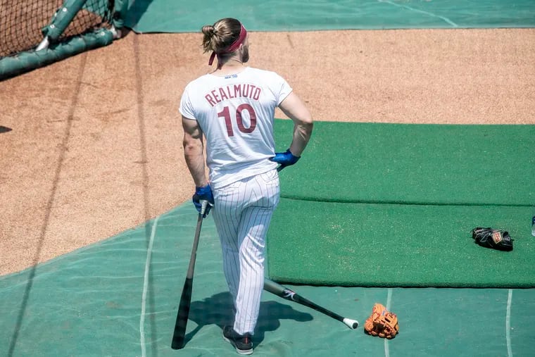 Phillies outfielder Bryce Harper, wearing a J.T. Realmuto giveaway shirt from last season, waits for his turn in batting practice on Friday at Citizens Bank Park.