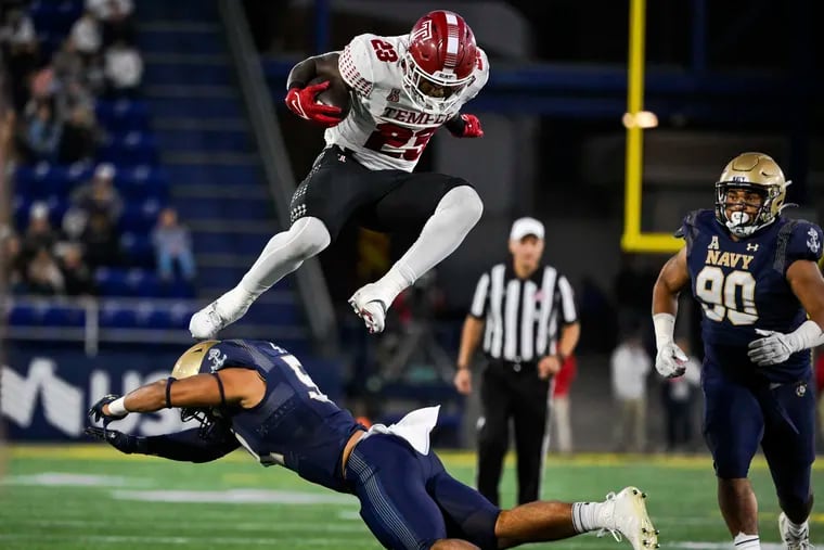 Temple running back Edward Saydee (23) hurdles Navy linebacker Nicholas Straw during the second half of the Owls matchup with the Midshipmen. Temple fell in overtime, 27-20.