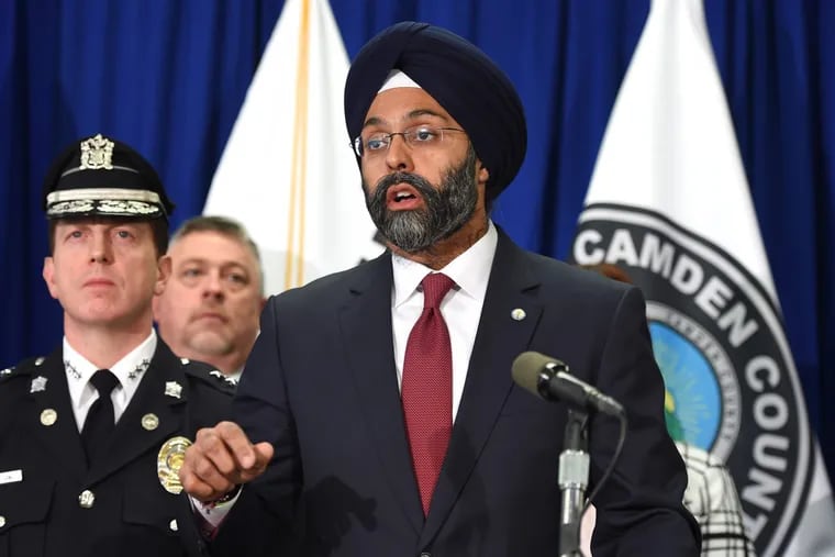 New Jersey Attorney General Gurbir Grewal (right) is joined by  Camden County Police Chief Scott Thomson (left) at press conference Feb. 14 announcing arrests in an interstate gun trafficking ring that brought weapons, including AK-47s into Camden.