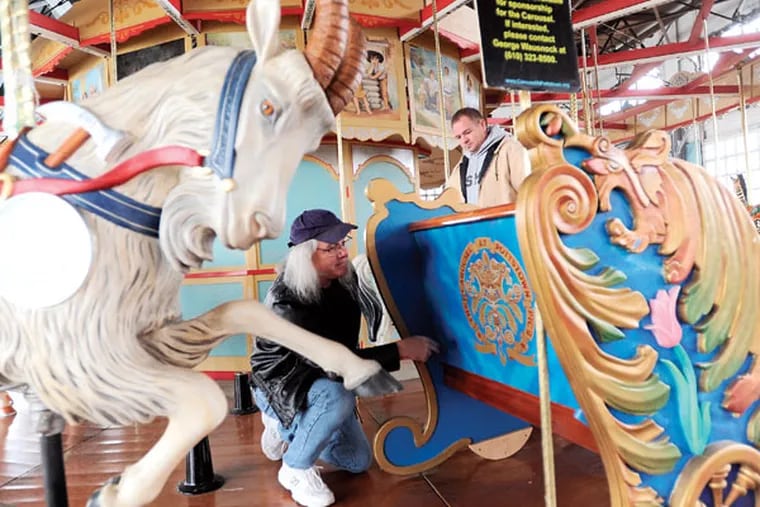 Chief mechanic Don Arters, right, and art director Alan MacBain review the recent installation of a new ride on the historic carousel Thursday, Dec. 11, 2014, in Pottstown.