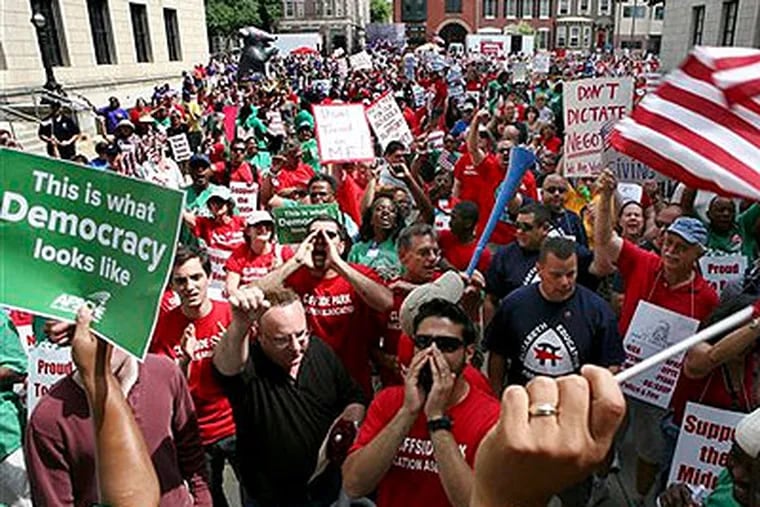 A large gathering of public employee union members and supporters protest Monday in Trenton, N.J., outside the Statehouse over plans by Gov. Chris Christie to reduce benefits and limit collective bargaining over health care for public workers. (AP Photo / Mel Evans)