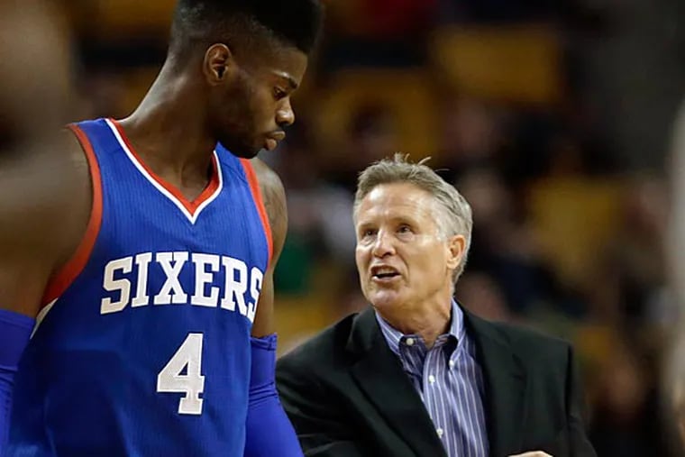 Philadelphia 76ers head coach Brett Brown, right, goes over a play with forward Nerlens Noel (4) during the second half of a preseason basketball game against the Boston Celtics in Boston, Monday, Oct. 6, 2014. The Celtics defeated the 76ers 98-78. (Charles Krupa/AP)