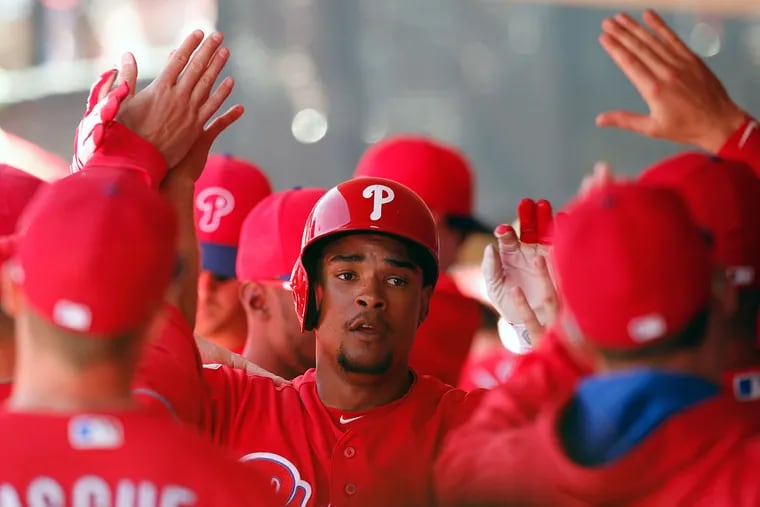 The Phillies' Cedric Hunter celebrates with teammates his second-inning run against Atlanta during a spring training game on Friday, March 4, 2016 in Clearwater, Florida.