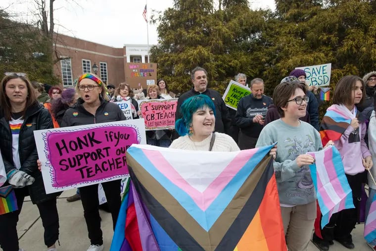 Demonstrators outside of Central Bucks West High School gathered in January to protest a school board vote that would ban Pride flags and other "advocacy" materials from classrooms.