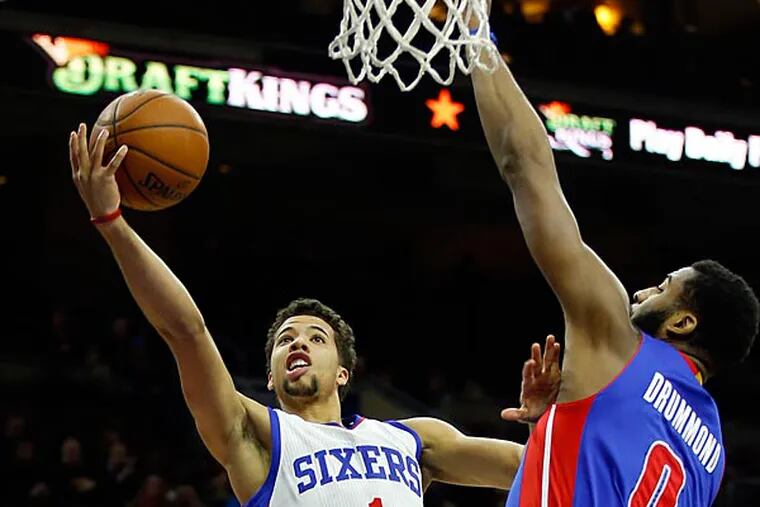 Michael Carter-Williams lays up the ball past the Pistons' Andre Drummond. (Yong Kim/Staff Photographer)