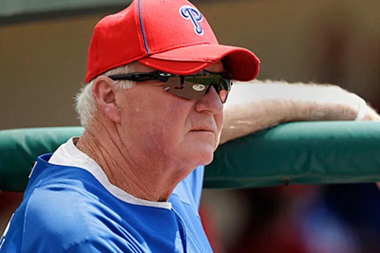 Phillies manager Charlie Manuel looks on during the first inning of a spring training game. (AP Photo/Charlie Riedel)