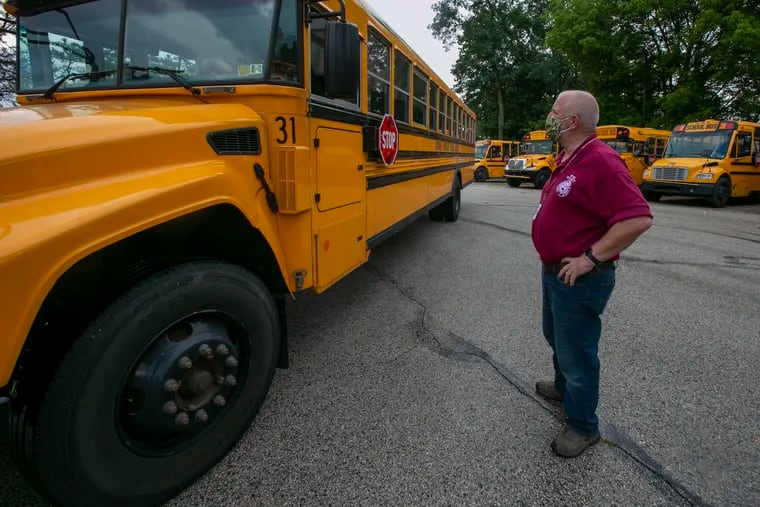 John Hearn, Radnor School District director of transportation, chats with a bus operator moving a bus around the lot. He referred to the pandemic as “just a different challenge for us, that’s all. The world changes, we got to be able to adapt to it.”