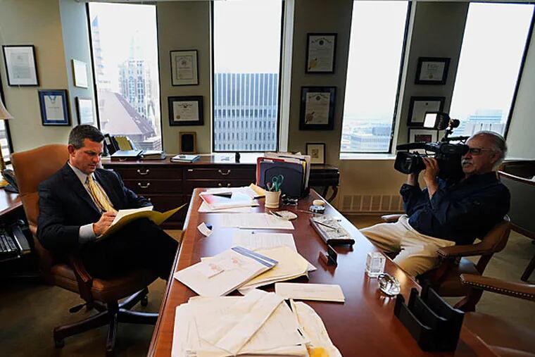 Attorney Steve Silverman, left, sits in his office Tuesday, May 20, 2014, in Baltimore. A group of retired players accused the NFL in a lawsuit Tuesday of cynically supplying them with powerful painkillers and other drugs that kept them in the game but led to serious complications later in life. The lawsuit, which seeks unspecified damages on behalf of more than 500 ex-athletes, charges the NFL with putting profits ahead of players' health. Silverman is an attorney for the players. (Gail Burton/AP)
