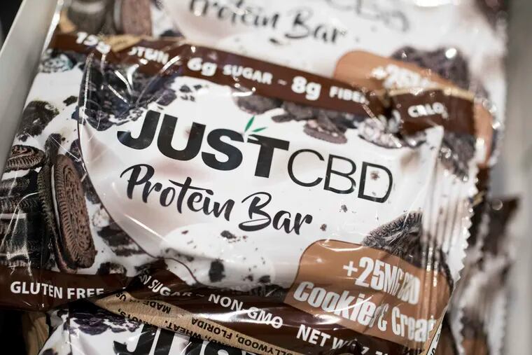 A cookies and cream flavored protein bar marketed by JustCBD is displayed at the Cannabis World Congress & Business Exposition trade show, Thursday, May 30, 2019 in New York. Technically, it is illegal to sell food with CBD because the substance is considered an FDA-approved drug. (AP Photo/Mark Lennihan)