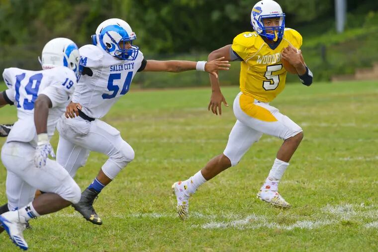 September 30, 2109 — Woodbury's Andre Parker runs the ball past Salem's Zuri Dublin (#19) and Savion Moore (#54) during the second half of Saturday's football game at Woodbury High School. Avi Steinhardt / For the Philadelphia Inquirer