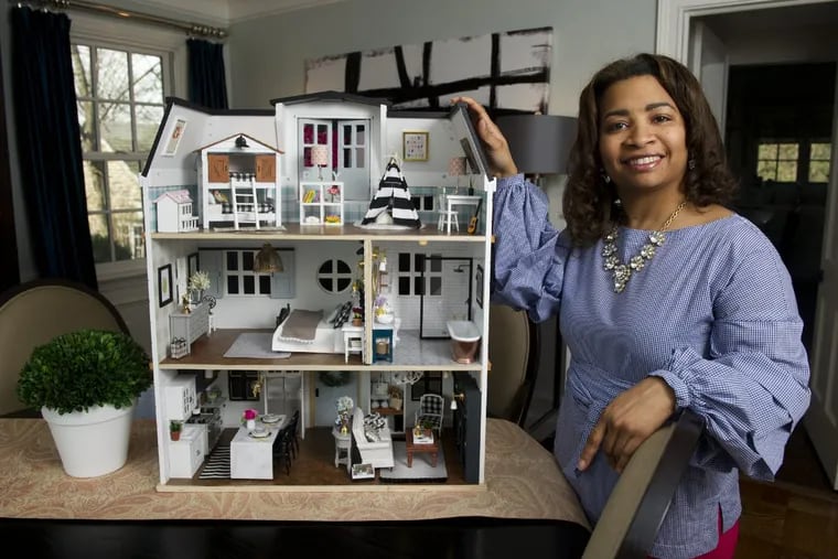 Dr. Kwandaa Roberts, a gynecologist, at Holy Redeemer Hospital, stands next to her dollhouse decorated in the style of HGTV’s Chip and Joanna Gaines of the TV show Fixer Upper.