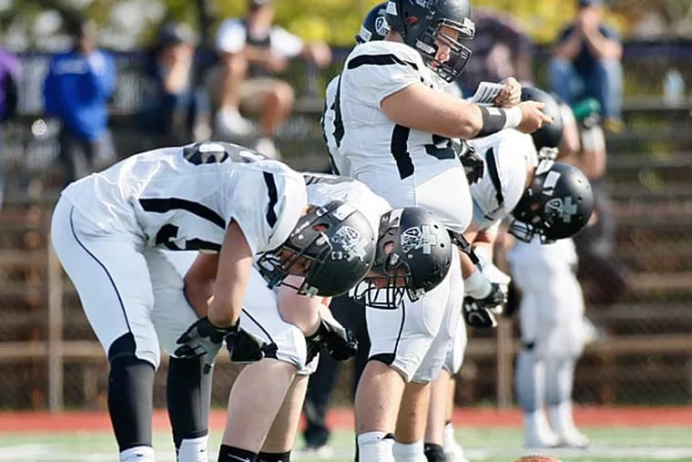 The Bishop Eustace offensive line looks to their wrist for the play. (Bishop Eustace/Staff Photographer)