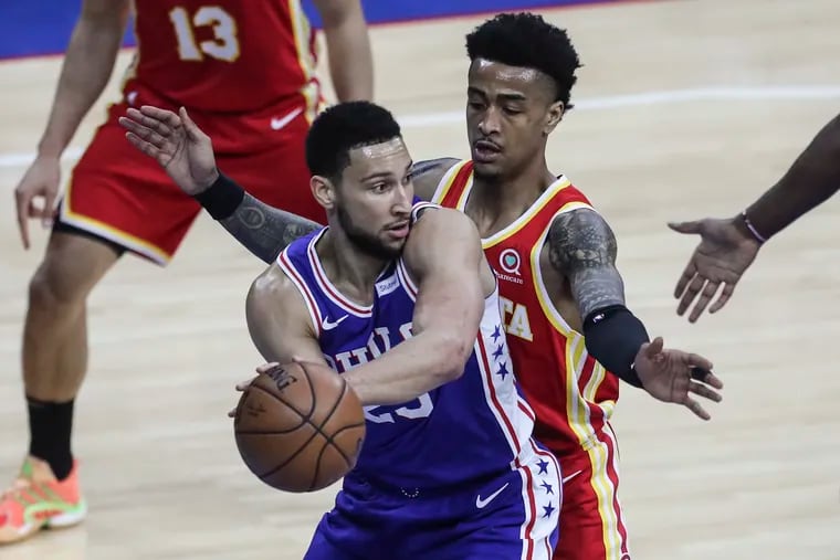 Ben Simmons of the Sixers looking to pass in front of Atlanta's John Collins during Game 5 of their playoff series in 2021.