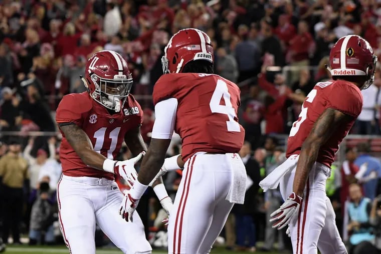 Jerry Jeudy (4) of Alabama is congratulated by teammate Henry Ruggs III (11) after scoring a touchdown against Clemson in the national championship game in January 2019.