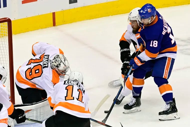 Flyers goaltender Carter Hart makes a save on New York Islanders left winger Anthony Beauvillier on Saturday. The Flyers are trying to avoid elimination Tuesday.