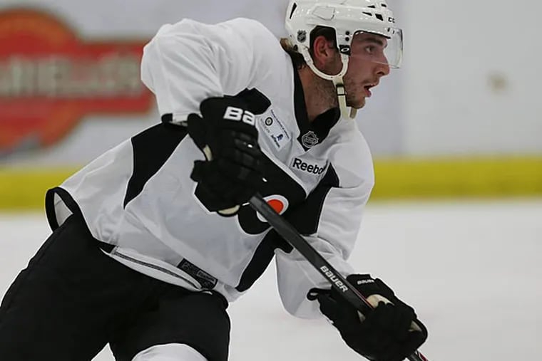 Shayne Gostisbehere passes the puck during a Flyers developmental camp. (David Maialetti/Staff Photographer)
