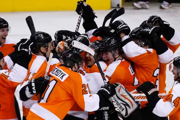 The Flyers celebrate with goalie Brian Boucher at the end of their dramatic 2-1 shootout win over the New York Rangers on April 11, 2010 at the Wachovia Center.