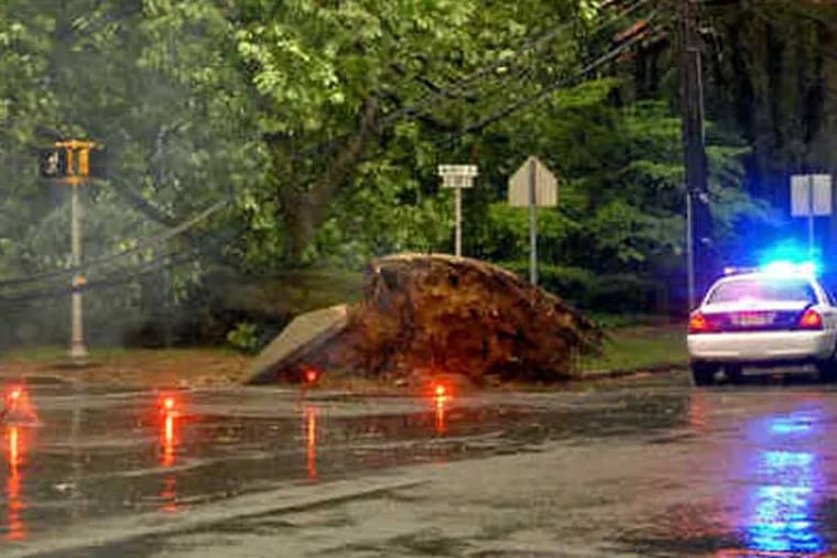 File photo: A corner of Kings Highway and Warwick Road in Haddonfield was in need of emergency work after a tree knocked down power lines in 2010. The storm affected about 4,000 PSEG customers in Burlington and Camden Counties. Also, 40,000 Atlantic City Electric customers lost power. (File photo: Tom Gralish / Staff Photographer)