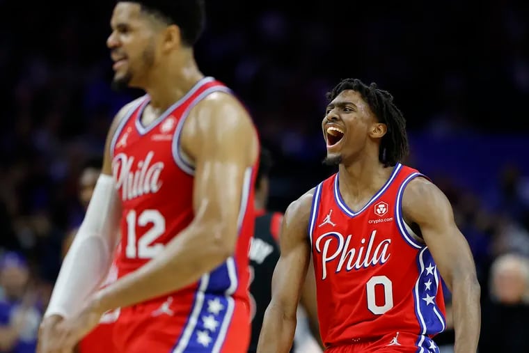 Sixers guard Tyrese Maxey and forward Tobias Harris cheer after teammate Danny Green's fourth-quarter dunk against the Toronto Raptors.