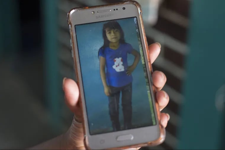 Paulina Gutierrez Alonzo, a 26-year-old Quiche indigenous woman, shows a photo of her 7-year-old daughter Antonia Yolanda Gomez Gutierrez on her cell phone during an interview at her grandfather's house in Joyabaj, Guatemala. Gutierrez Alonzo was deported from United States in June and separated from her daughter who is currently at an immigration center in Arizona, despite the Thursday deadline for reuniting children with their families who were caught entering the country without authorization.