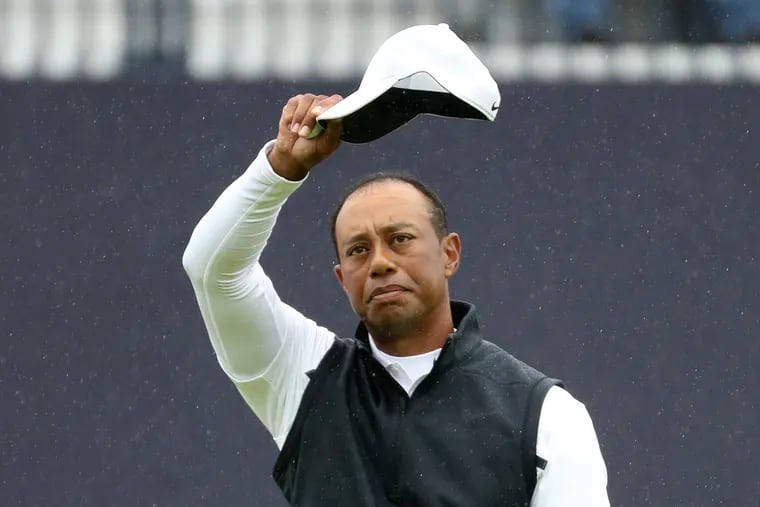 Tiger Woods of the United States waves his hat to the crowd as he completes his second round of the British Open Golf Championships at Royal Portrush in Northern Ireland. Woods finished at 6 over par for the two rounds and missed the cut.