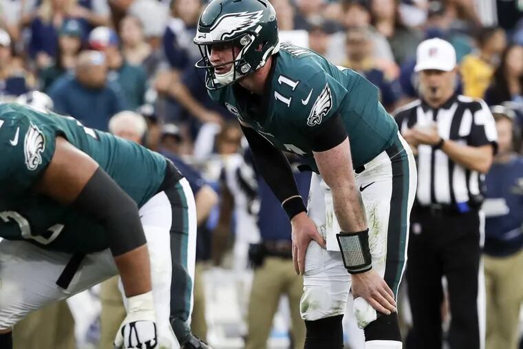 Eagles quarterback Carson Wentz rubs his knee before the Eagles scored in the third-quarter against the Los Angeles Rams on Sunday, December 10, 2017. YONG KIM / Staff Photographer