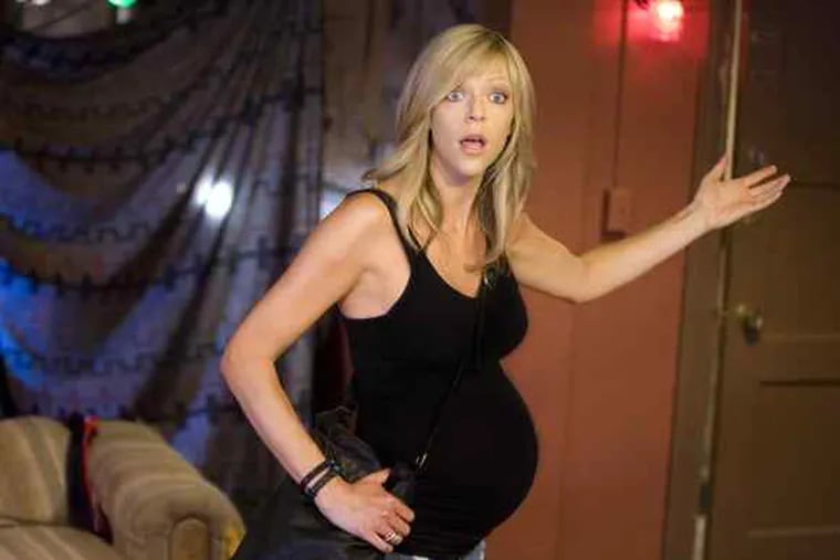 A pregnant Kaitlin Olson in a scene from next season's &quot;It's Always Sunny in Philadelphia.&quot; Her husband is series creator-star Rob McElhenney; her character, Sweet Dee, might have some explaining to do.