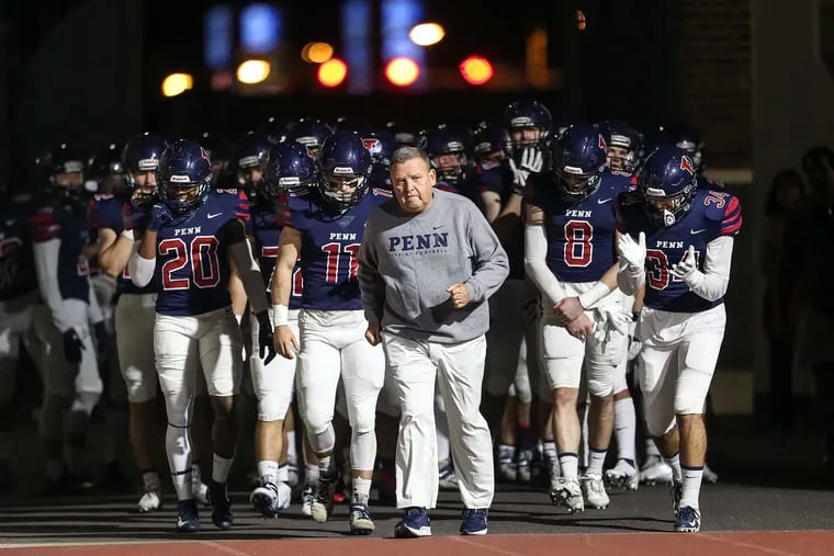 Penn's first-year sprint football coach Jerry McConnell leads his team onto Franklin Field on Oct. 22.