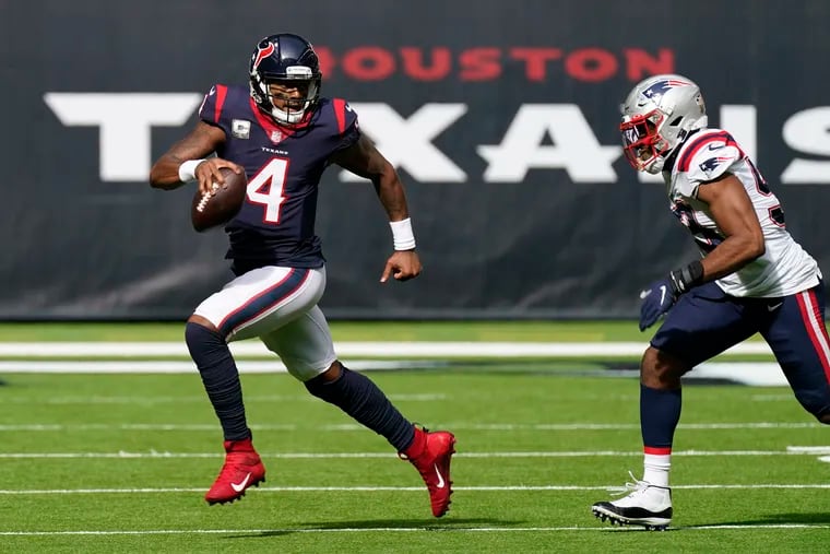 Texans quarterback Deshaun Watson runs past Patriots linebacker Josh Uche on Sunday.