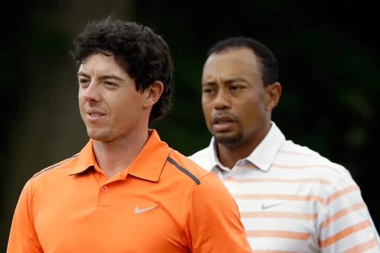 Rory McIlroy (left) and Tiger Woods walk across the 10th green after putting during the second round of the U.S. Open golf tournament at Merion Golf Club, Friday, June 14, 2013, in Ardmore, Pa. (Gene J. Puskar/AP)