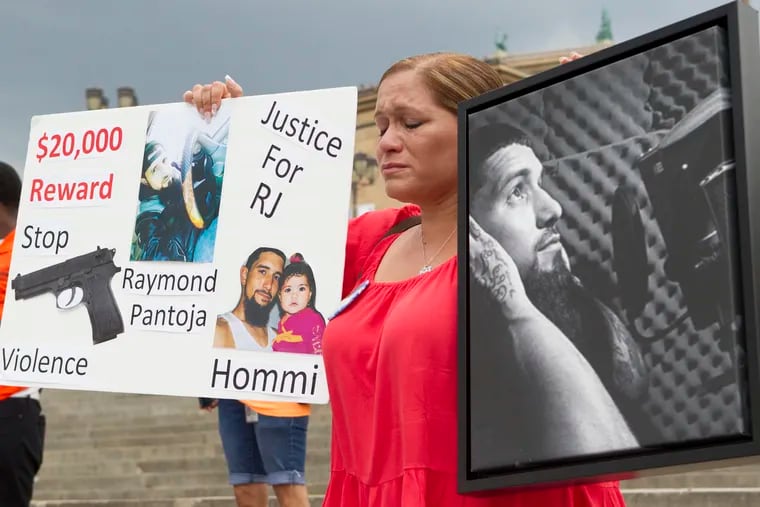 Philadelphians who have been impacted by gun violence gather on the steps of the Art Museum on June 22, 2016.  Lisa Espinosa holds photoS of her son, Raymond Pantoja who was killed on April 10, 2016. Since the beginning of the year, more than 500 people in Philadelphia have been shot and more than 100 have been killed. As of today, shootings are up 24 percent  CHARLES FOX / Staff Photographer