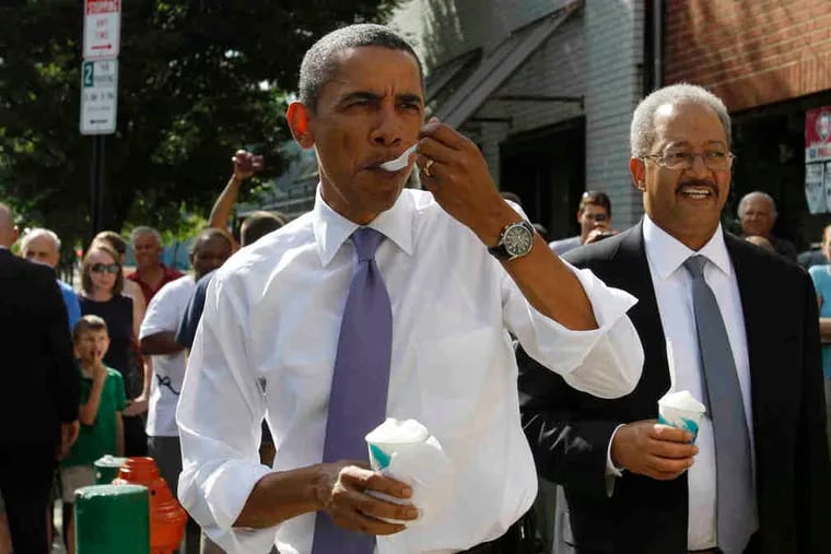 Obama tries the lemon water ice at John's in South Philly, with U.S. Rep. Chaka Fattah at his side.