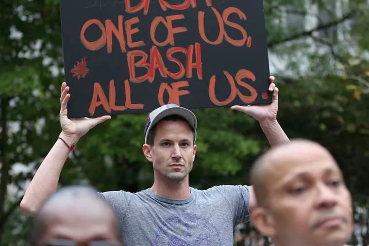 Matt Beierschmitt, of Center City, takes a selfie as he holds a sign during a rally to support hate crime legislation at Love Park on September 25, 2014 in Philadelphia. ( DAVID MAIALETTI / Staff Photographer )