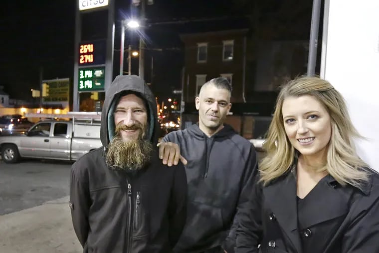 Johnny Bobbitt Jr. (left), Mark D'Amico, and Kate McClure at the CITGO station where Bobbitt said he spent his last $20 to buy gas for McClure.