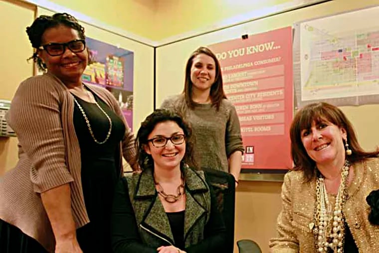 ( L - R ) Dawn Sommerville, Ivy Olesh, Cassandra Dominiguez, and vice president Michelle Shannon, from CCD, the City Commerce Department, & PIDC (Phila Industrial Development Corp.) will be pitching Philly to retailers & landlords from a CCD booth on Monday in New York City at the annual International Council of Shopping Centers convention, Wednesday December 4, 2013. ( DAVID SWANSON / Staff Photographer )