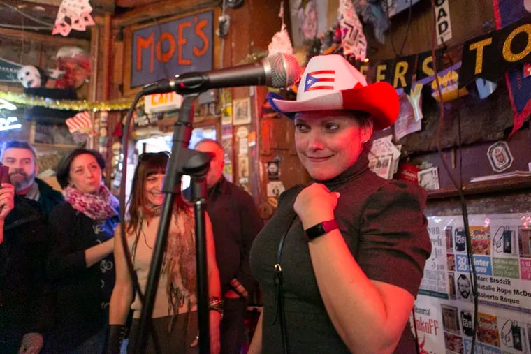 Rita Portela delivers a speech after winning Dirty Franks' Customer of the Year award during its annual ceremony on Sunday, March 1, 2020. Co-owner Jody Sweitzer, in the background, made a custom prize — a Puerto Rico-themed cowboy hat.
