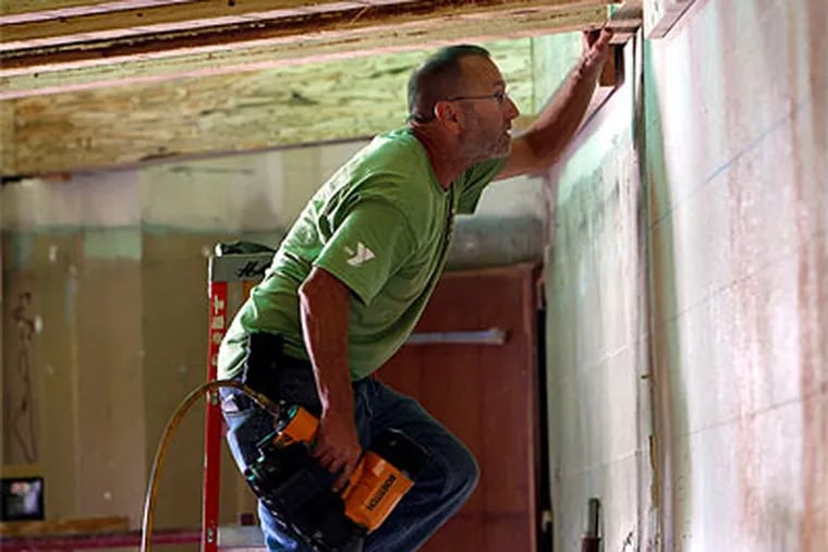 Paul Willman , a volunteer from Boyertown, Pa., helps on the dining hall project. (David Maialetti / Staff Photographer)