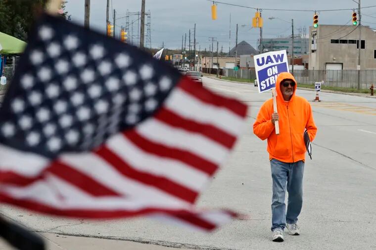 Rocky Perry, a 20-year General Motors employee, pickets outside the GM Fabrication Division, Wednesday, Oct. 16, 2019, in Parma, Ohio. Bargainers for GM and the United Auto Workers reached a tentative contract deal on Wednesday that could end a monthlong strike that brought the company's U.S. factories to a standstill. (AP Photo/Tony Dejak)