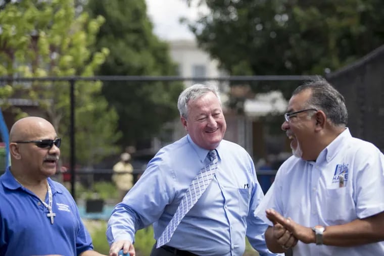 Philadelphia Mayor Jim Kenney shares a laugh as he plays wall ball before the ribbon-cutting ceremony at Jose Manuel Callazo Playground June 19, 2017. The park is being renovated through a private-public partnership, Parks for People. More park renovations are promised through the city's Rebuild program.