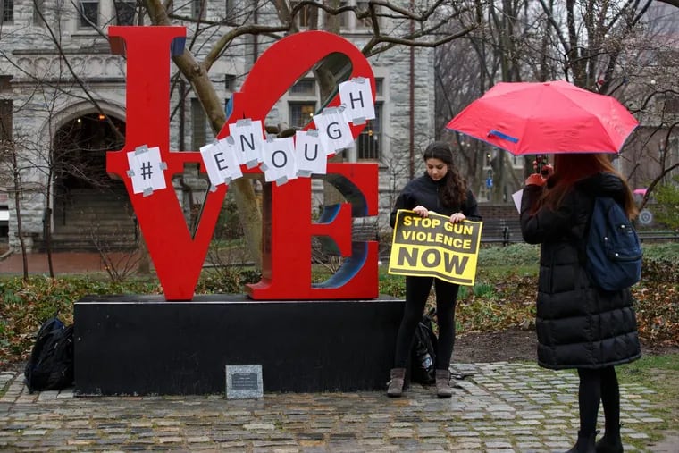 Nicole Rubin poses for a photo with the LOVE statue on Locust Walk on Penn’s campus after a Thursday protest against gun violence.
