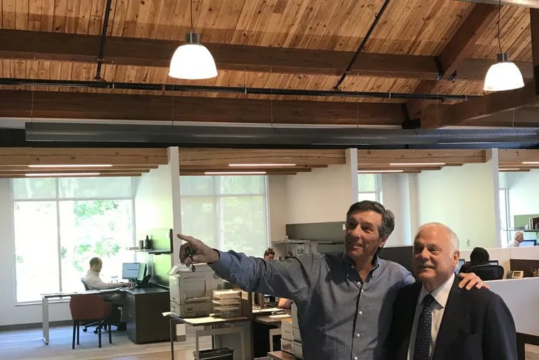 Developer/philanthropist Dan DiLella, left, and leasing-company owner/nonprofit-turnaround veteran Frank Giordano, at the new Newtown Square headquarters of DiLella's development company, Equus, decorated with wood salvaged from defunct Berks County factories. President Trump appointed Giordano to head the U.S. Semiquincennial Commission to start planning the country's 250th birthday. Giordano is executive director. They're looking for a name, and plans, and a budget. (CREDIT: Joseph N. DiStefano)